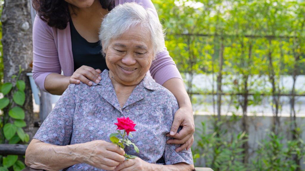 Caregiver gently helping parent with dementia brush teeth