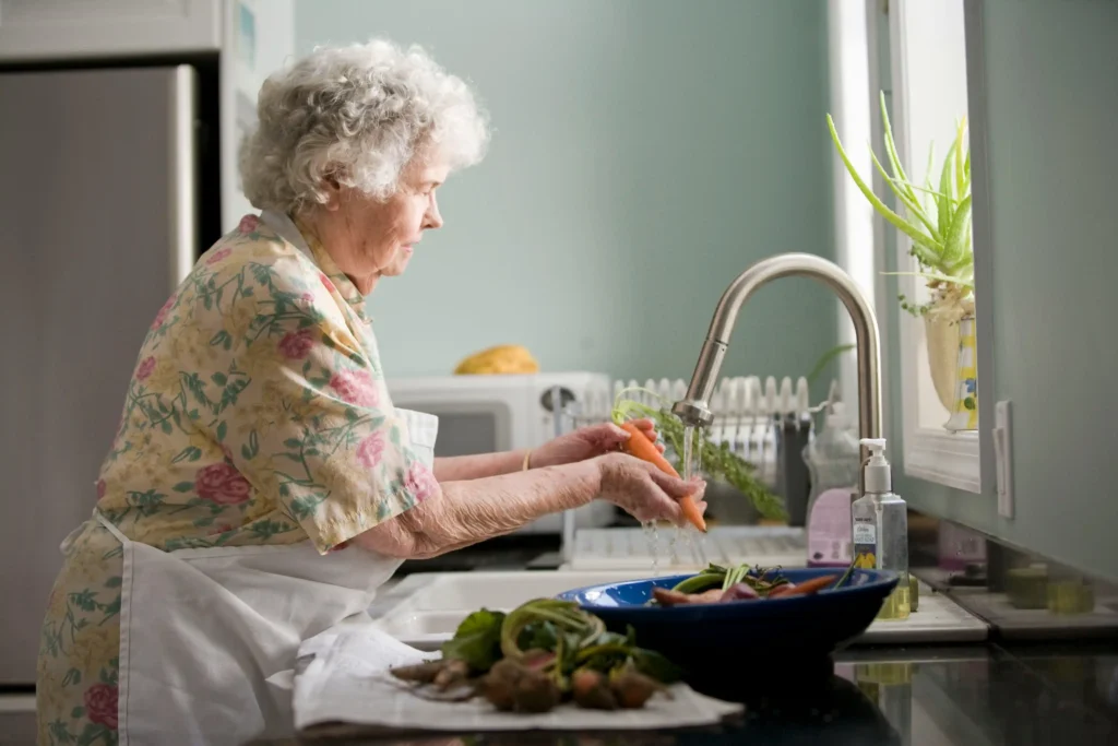 senior parent using accessible kitchen with aging in place home improvements