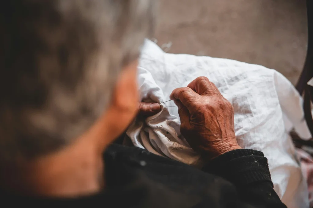 elderly person touching fabric texture