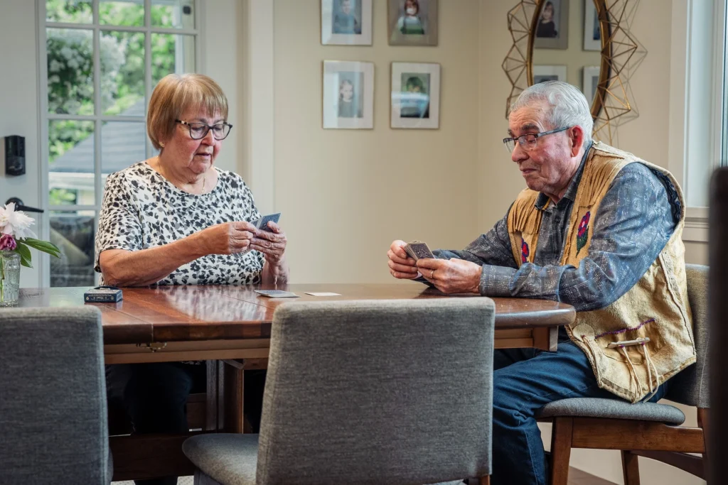 Large-print memory card game used for dementia-friendly trivia with senior