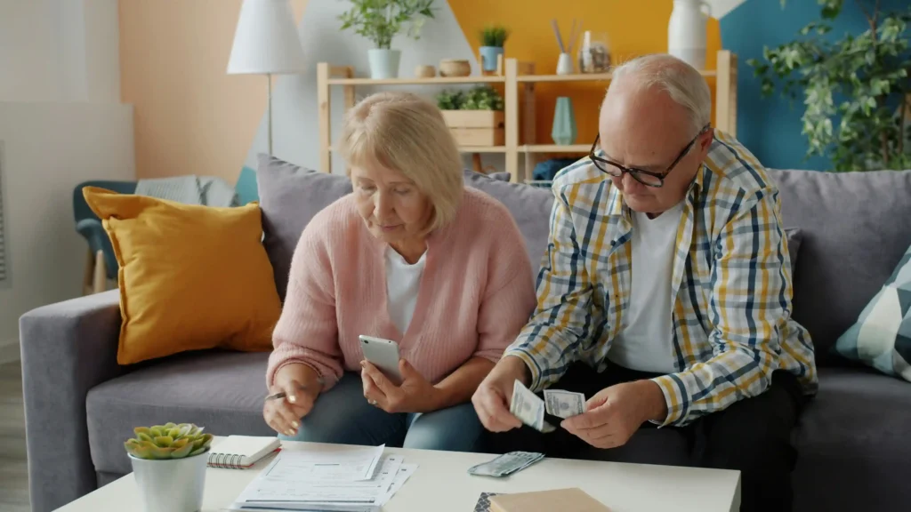 Elderly veteran and family reviewing VA Aid and Attendance benefits paperwork