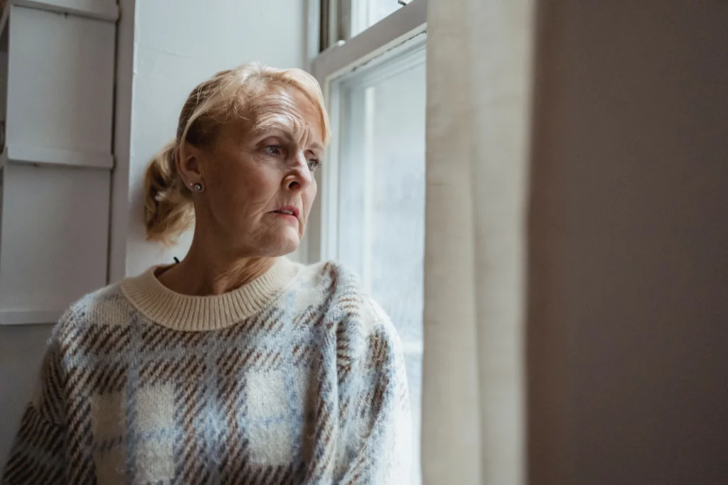 senior woman alone worried living room